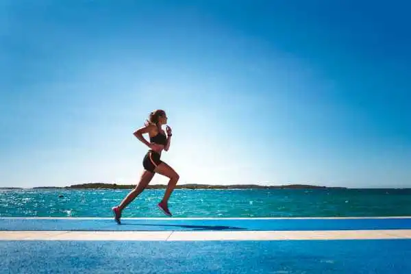 Woman running showing strong leg muscle Weston Super Mare